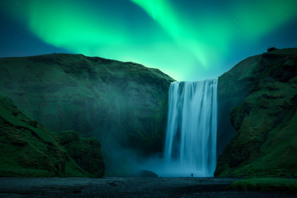 Northern lights over Sk&oacute;gafoss waterfall in Iceland